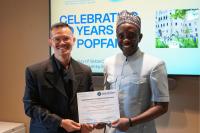 Dr. Thoai Ngo and Hon. Chernor Bah holding a signed MOU